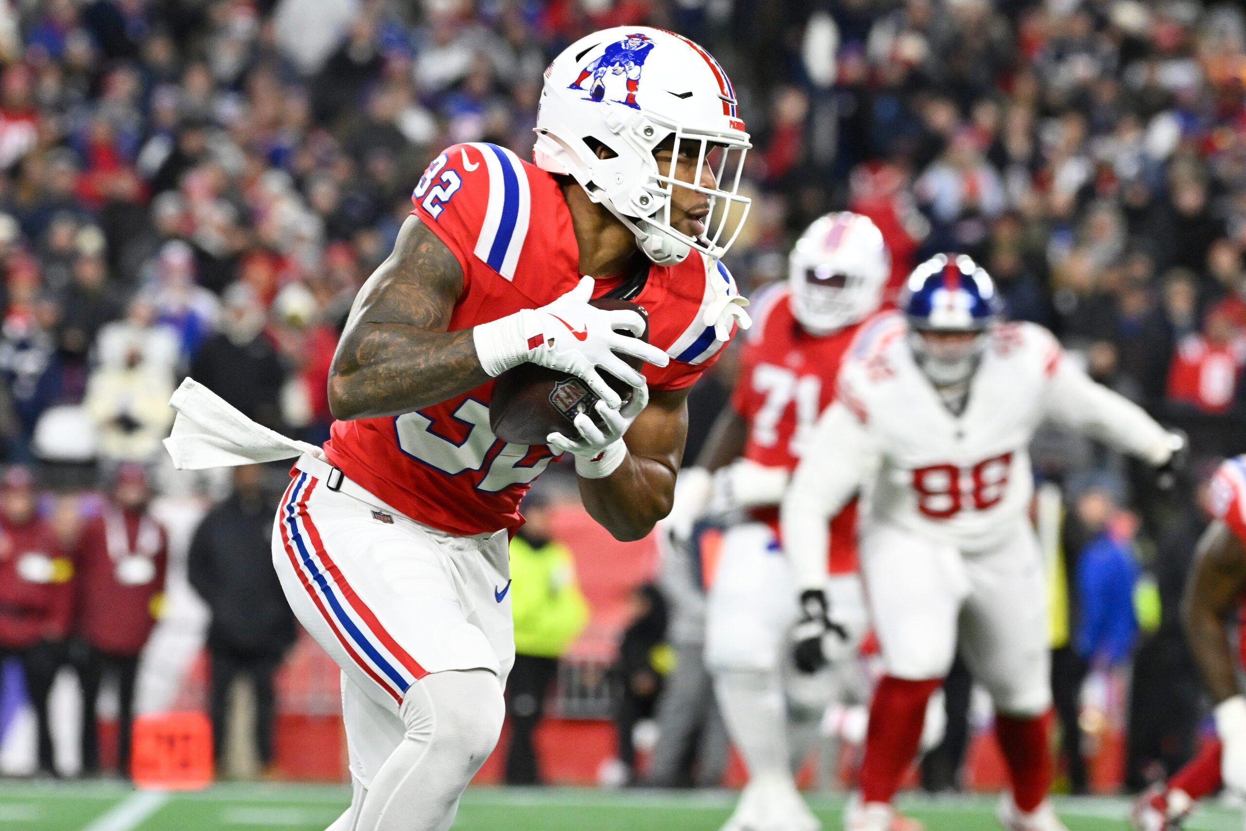 Dec 1, 2025; Foxborough, Massachusetts, USA; New England Patriots running back TreVeyon Henderson (32) runs the ball during the second quarter against the New York Giants at Gillette Stadium. Mandatory Credit: Eric Canha-Imagn Images