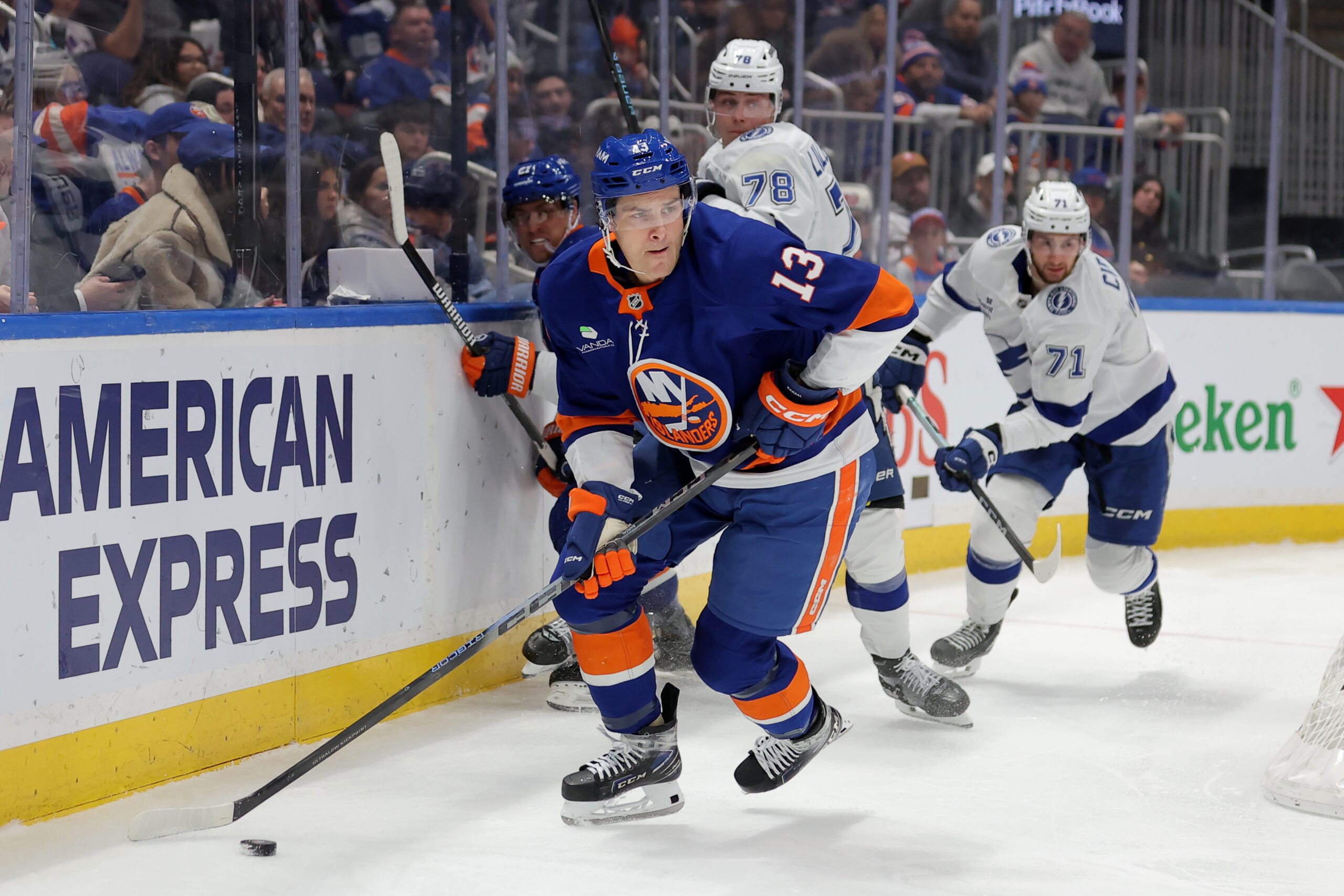 Dec 2, 2025; Elmont, New York, USA; New York Islanders center Mathew Barzal (13) controls the puck against Tampa Bay Lightning defenseman Emil Lilleberg (78) and center Anthony Cirelli (71) during the second period at UBS Arena. Mandatory Credit: Brad Penner-Imagn Images