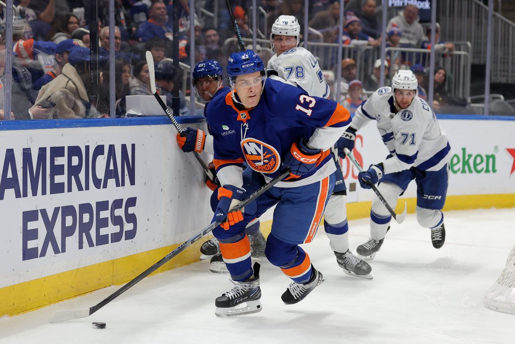 Dec 2, 2025; Elmont, New York, USA; New York Islanders center Mathew Barzal (13) controls the puck against Tampa Bay Lightning defenseman Emil Lilleberg (78) and center Anthony Cirelli (71) during the second period at UBS Arena. Mandatory Credit: Brad Penner-Imagn Images