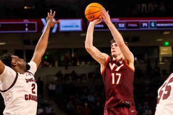 Dec 2, 2025; Columbia, South Carolina, USA; Virginia Tech Hokies guard Neoklis Avdalas (17) shoots over South Carolina Gamecocks forward Christ Essandoko (2) in the second half at Colonial Life Arena. Mandatory Credit: Jeff Blake-Imagn Images