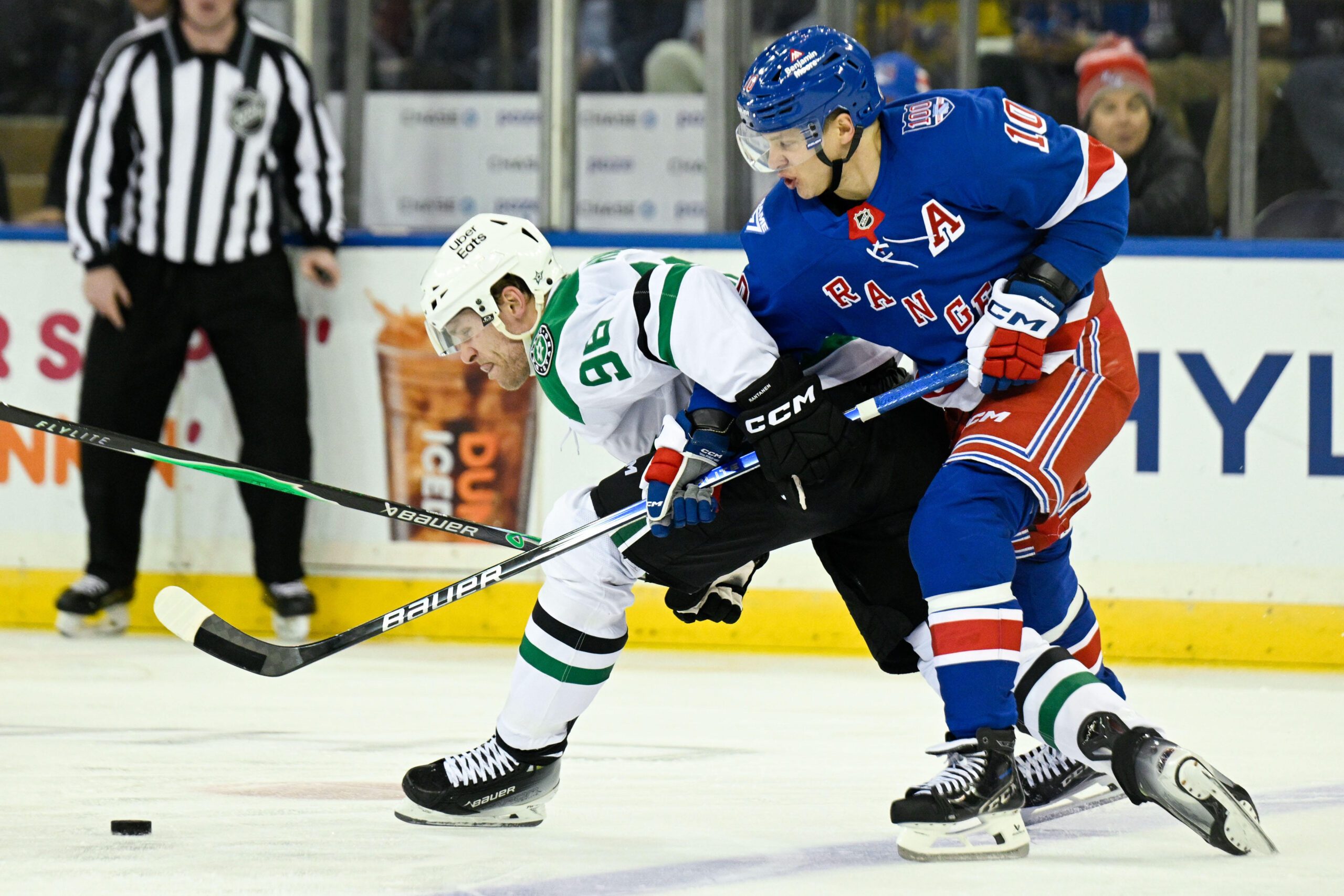 Dec 2, 2025; New York, New York, USA;  New York Rangers left wing Artemi Panarin (10) and Dallas Stars right wing Mikko Rantanen (96) battle for the puck during the third period at Madison Square Garden. Mandatory Credit: Dennis Schneidler-Imagn Images