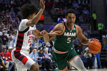 Dec 2, 2025; Oxford, Mississippi, USA; Miami Hurricanes forward Malik Reneau (5) drives to the basket as Mississippi Rebels guard Patton Pinkins (23) defends during the first half at The Sandy and John Black Pavilion at Ole Miss. Mandatory Credit: Petre Thomas-Imagn Images