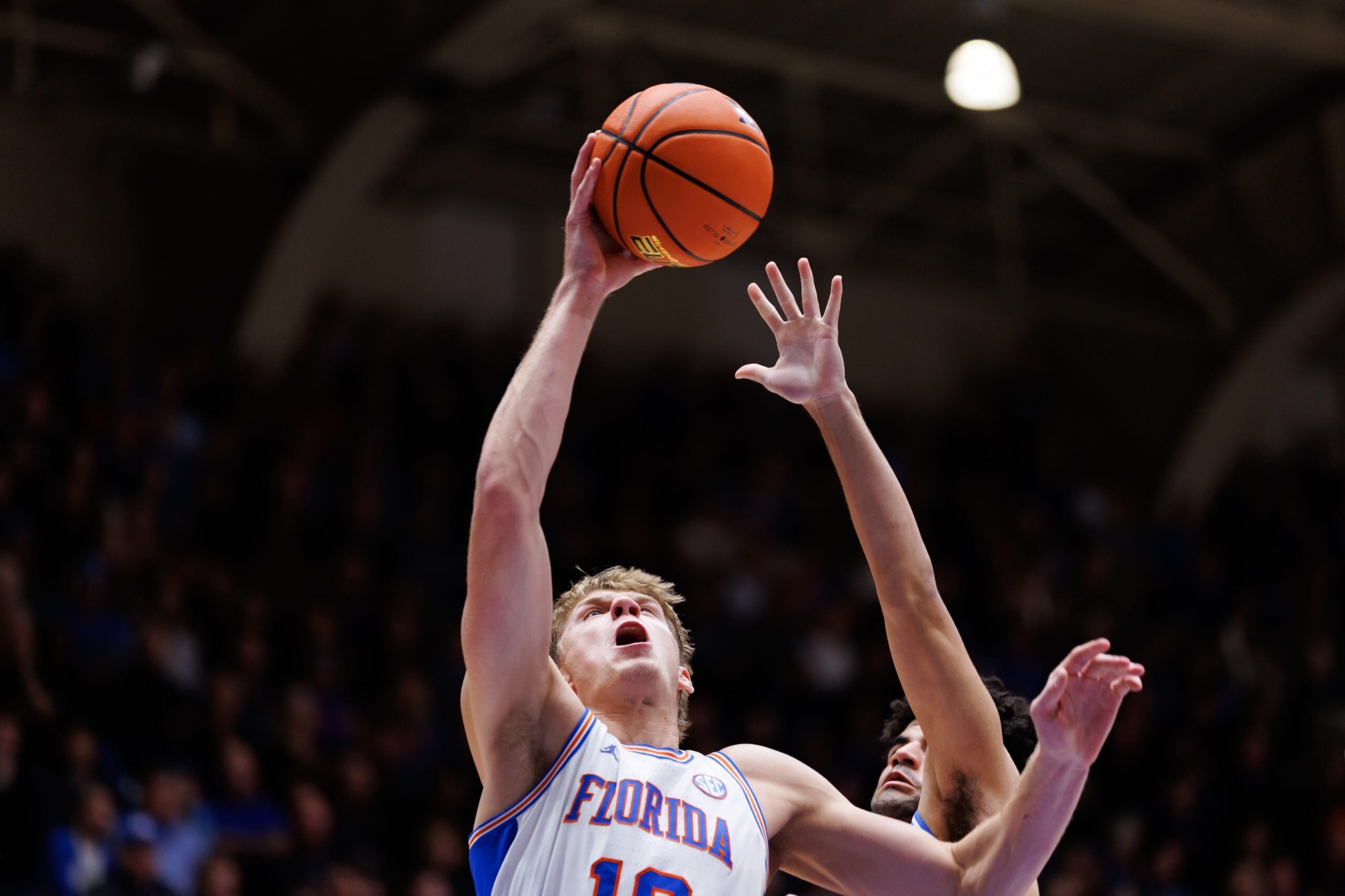 Florida Gators forward Thomas Haugh (10) makes a layup over Duke Blue Devils forward Cameron Boozer (12) during the first half at Cameron Indoor Stadium in Durham, NC on Tuesday, December 2, 2025. [Matt Pendleton/Gainesville Sun]