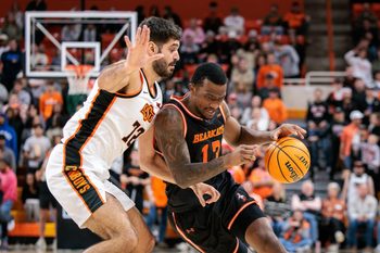 Dec 2, 2025; Stillwater, Oklahoma, USA; Sam Houston Bearkats forward Isaiah Manning (13) drives to the basket around Oklahoma State Cowboys forward Lefteris Mantzoukas (72) during the second half at Gallagher-Iba Arena. Mandatory Credit: William Purnell-Imagn Images