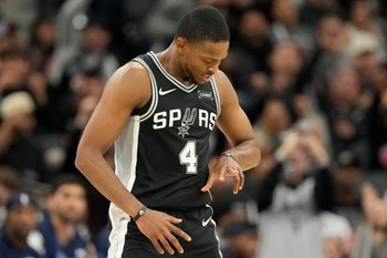 Dec 2, 2025; San Antonio, Texas, USA; San Antonio Spurs guard De’Aaron Fox (4) reacts after scoring a three point basket during the second half against the Memphis Grizzlies at Frost Bank Center. Mandatory Credit: Scott Wachter-Imagn Images