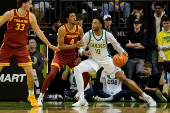 Oregon forward Kwame Evans Jr., right, presses toward the basket under cover from USC guard Chad Baker-Mazara as the Oregon Ducks host the USC Trojans at Matthew Knight Arena in Eugene, Oregon on Dec. 2, 2025.
