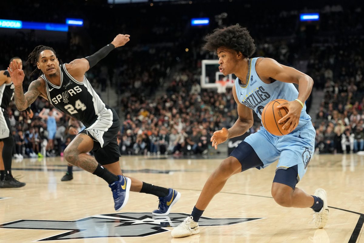 Dec 2, 2025; San Antonio, Texas, USA; Memphis Grizzlies guard Jaylen Wells (0)drives to the basket against San Antonio Spurs guard Devin Vassell (24) during the second half at Frost Bank Center. Mandatory Credit: Scott Wachter-Imagn Images