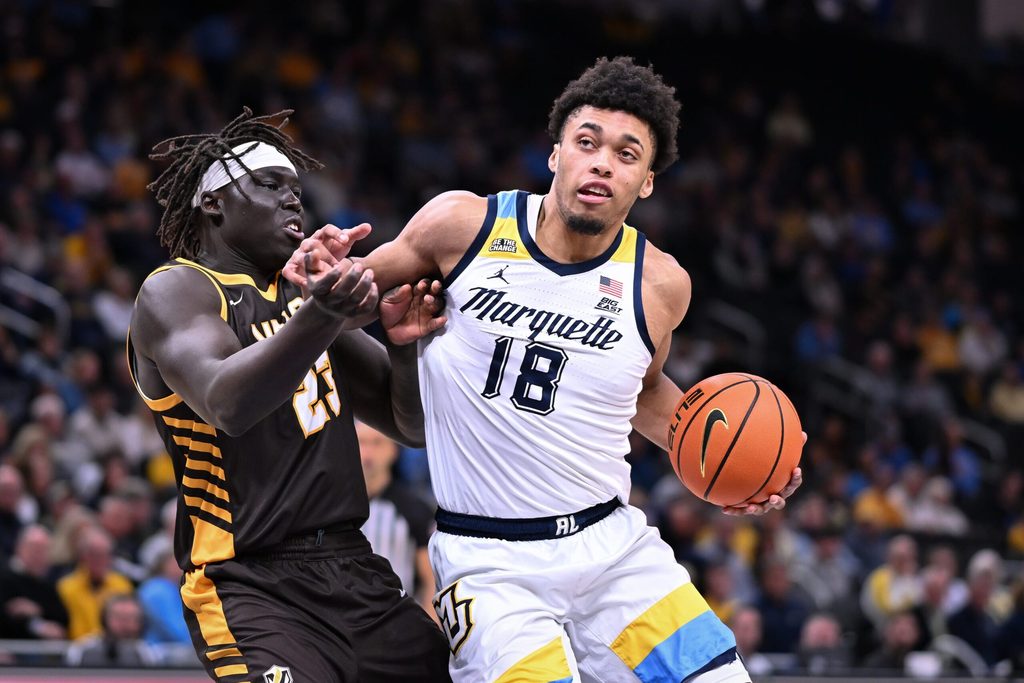 Marquette forward Caedin Hamilton (18) goes to the basket against Valparaiso center Shon Tupuola (23) in the first half of a game Tuesday, December 2, 2025, at Fiserv Forum in Milwaukee, Wisconsin.
