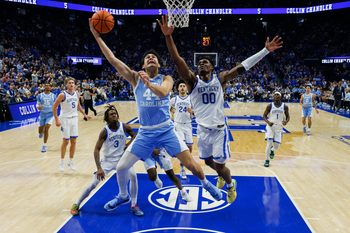 Dec 2, 2025; Lexington, Kentucky, USA; North Carolina Tar Heels guard Luka Bogavac (44) goes to the basket agaisnt Kentucky Wildcats guard Otega Oweh (00) during the first half at Rupp Arena at Central Bank Center. Mandatory Credit: Jordan Prather-Imagn Images