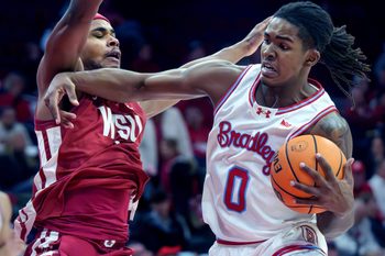 Bradley’s Demarion Burch, right, tangles with Washington State’s Jerone Morton in the first half of their college basketball game Tuesday, Dec. 2, 2025 at Carver Arena in Peoria. The Braves rallied for a 64-60 victory.