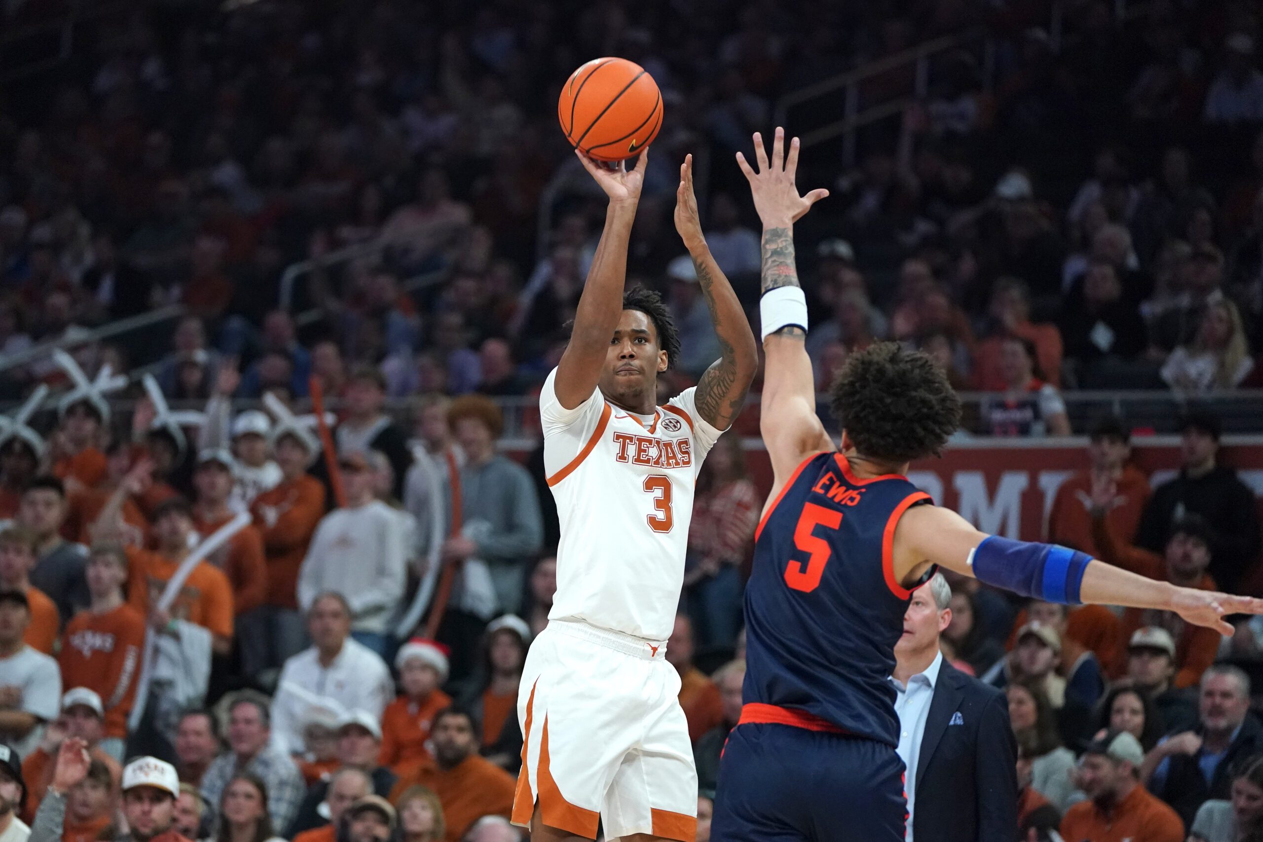 Dec 3, 2025; Austin, Texas, USA; Texas Longhorns guard Dailyn Swain (3) shoots a three point basket against Virginia Cavaliers guard Sam Lewis (5) during the first half at Moody Center. Mandatory Credit: Dustin Safranek-Imagn Images