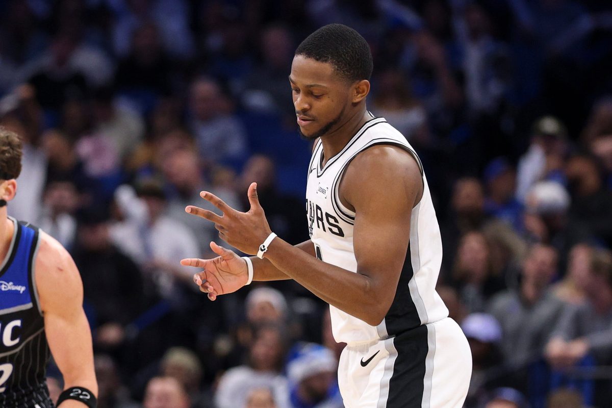 Dec 3, 2025; Orlando, Florida, USA; San Antonio Spurs guard De'Aaron Fox (4) reacts after a three point basket against the Orlando Magic in the fourth quarter at Kia Center. Mandatory Credit: Nathan Ray Seebeck-Imagn Images