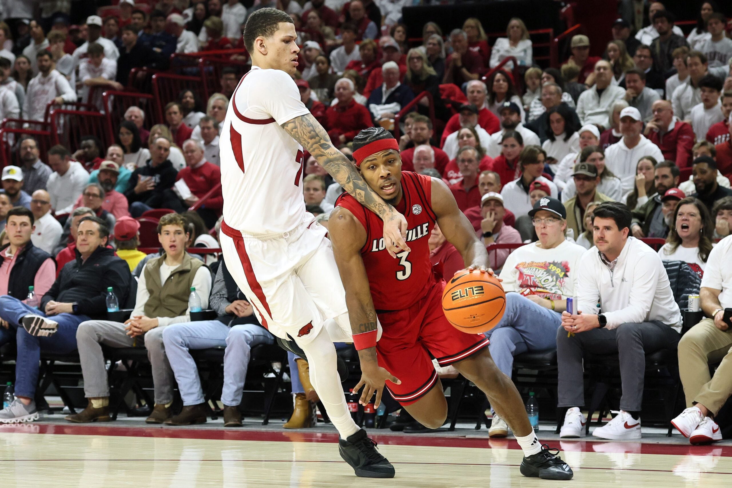 Dec 3, 2025; Fayetteville, Arkansas, USA; Louisville Cardinals guard Ryan Conwell (3) drives against Arkansas Razorbacks forward Trevon Brazile (7) during the second half at Bud Walton Arena. Arkansas won 89-80. Mandatory Credit: Nelson Chenault-Imagn Images