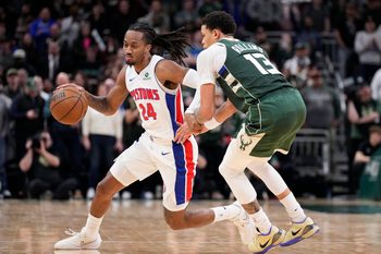Dec 3, 2025; Milwaukee, Wisconsin, USA; Detroit Pistons guard Daniss Jenkins (24) brings the ball up the court against Milwaukee Bucks guard Ryan Rollins (13) in the second half at Fiserv Forum. Mandatory Credit: Michael McLoone-Imagn Images