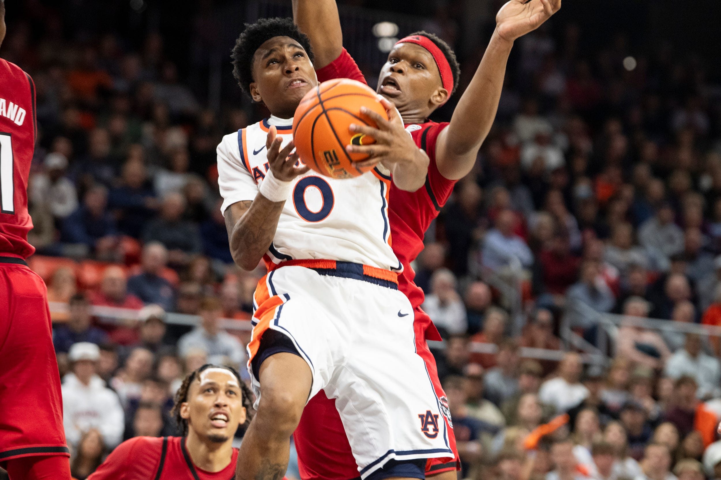Auburn Tigers guard Tahaad Pettiford (0) goes up for a layup as Auburn Tigers take on NC State Wolfpack at Neville Arena in Auburn, Ala. on Wednesday, Dec. 3, 2025. Auburn Tigers defeated NC State Wolfpack 83-73.