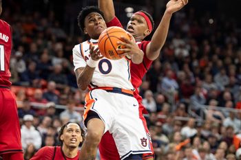 Auburn Tigers guard Tahaad Pettiford (0) goes up for a layup as Auburn Tigers take on NC State Wolfpack at Neville Arena in Auburn, Ala. on Wednesday, Dec. 3, 2025. Auburn Tigers defeated NC State Wolfpack 83-73.