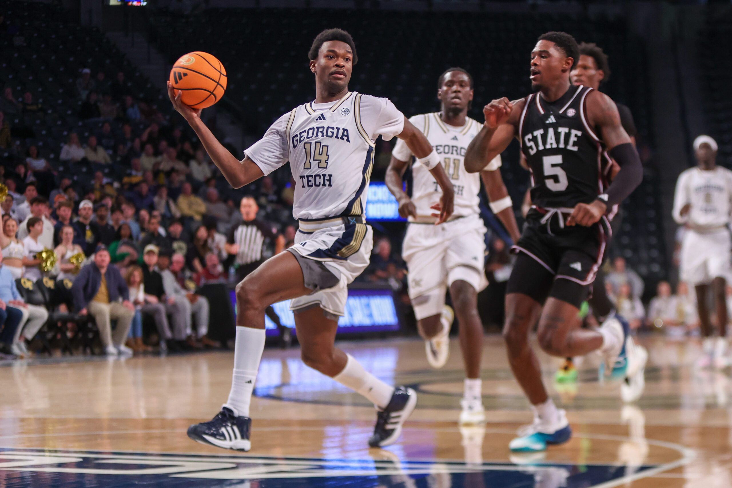 Dec 3, 2025; Atlanta, Georgia, USA; Georgia Tech Yellow Jackets forward Kowacie Reeves Jr. (14) drives past Mississippi State Bulldogs guard Shawn Jones Jr. (5) in the second half at McCamish Pavilion. Mandatory Credit: Brett Davis-Imagn Images