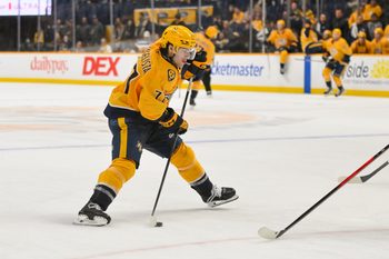 Dec 2, 2025; Nashville, Tennessee, USA;  Nashville Predators right wing Luke Evangelista (77) takes a shot on goal against the Calgary Flames during the third period at Bridgestone Arena. Mandatory Credit: Steve Roberts-Imagn Images