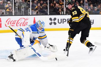 Dec 4, 2025; Boston, Massachusetts, USA; St. Louis Blues goaltender Jordan Binnington (50) makes a save on Boston Bruins center Fraser Minten (93) during the first period at TD Garden. Mandatory Credit: Bob DeChiara-Imagn Images