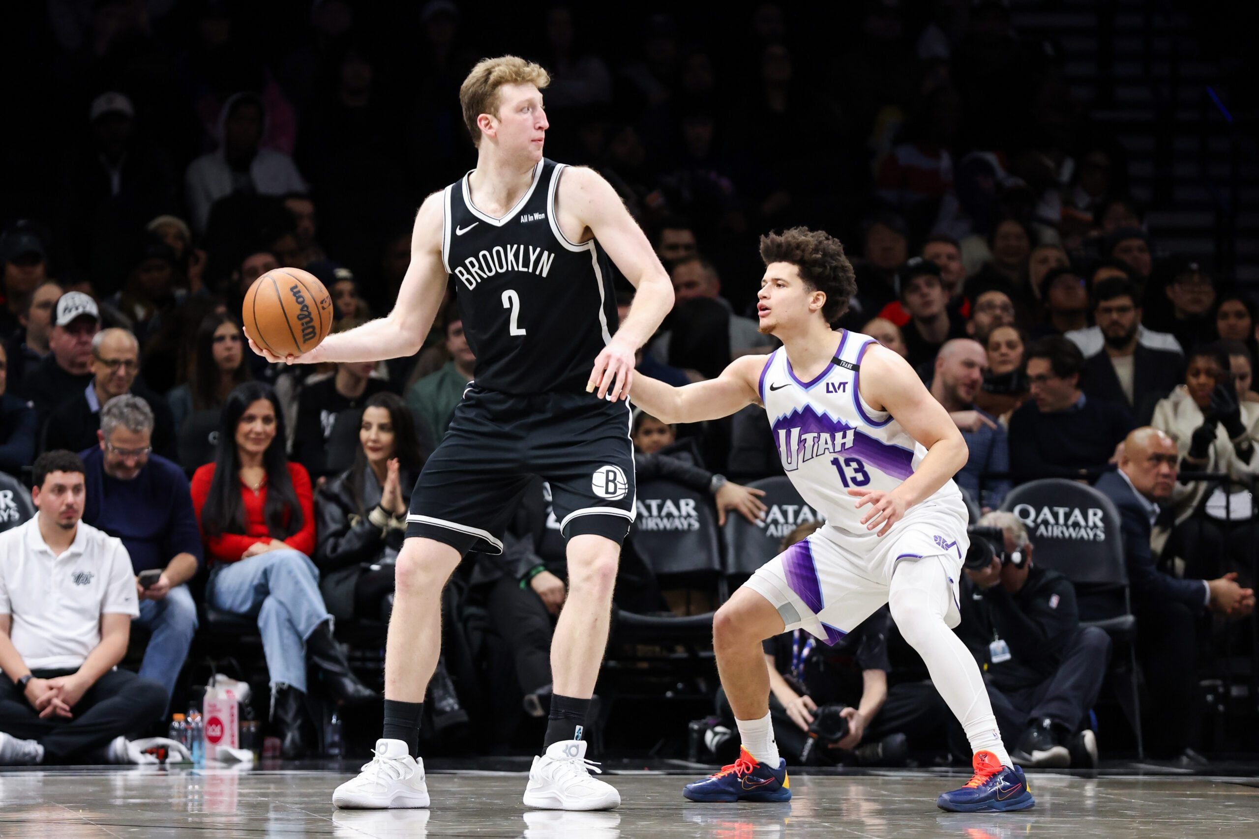 Dec 4, 2025; Brooklyn, New York, USA; Brooklyn Nets forward Danny Wolf (2) looks to move the ball past Utah Jazz guard Walter Clayton Jr. (13) during the fourth quarter at Barclays Center. Mandatory Credit: Tom Horak-Imagn Images