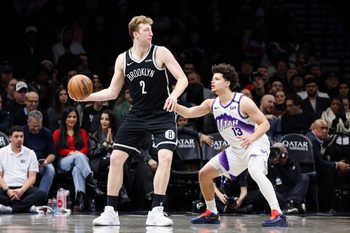Dec 4, 2025; Brooklyn, New York, USA; Brooklyn Nets forward Danny Wolf (2) looks to move the ball past Utah Jazz guard Walter Clayton Jr. (13) during the fourth quarter at Barclays Center. Mandatory Credit: Tom Horak-Imagn Images