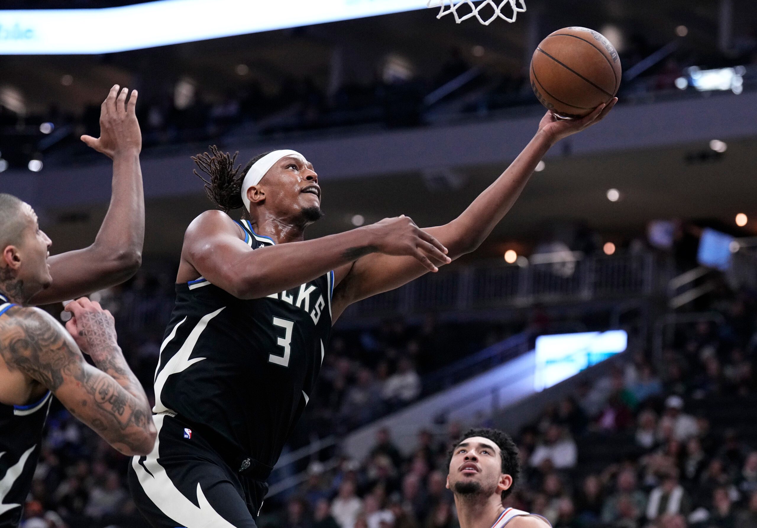Dec 5, 2025; Milwaukee, Wisconsin, USA; Milwaukee Bucks center Myles Turner (3) lays the ball up for a shot against the Philadelphia 76ers in the first half at Fiserv Forum. Mandatory Credit: Michael McLoone-Imagn Images