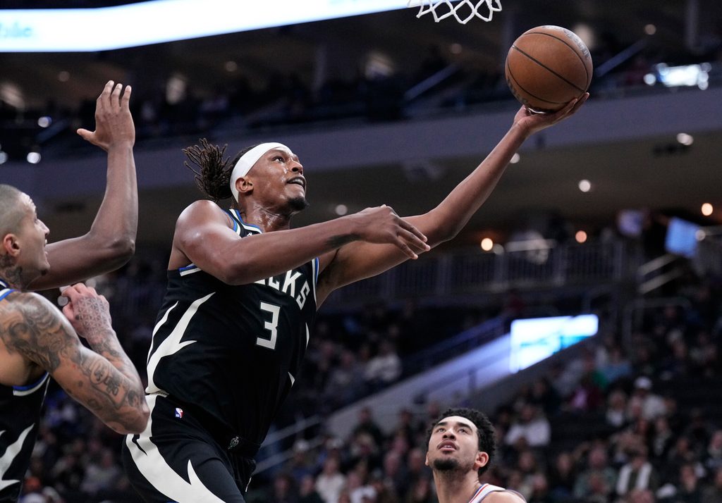 Dec 5, 2025; Milwaukee, Wisconsin, USA; Milwaukee Bucks center Myles Turner (3) lays the ball up for a shot against the Philadelphia 76ers in the first half at Fiserv Forum. Mandatory Credit: Michael McLoone-Imagn Images