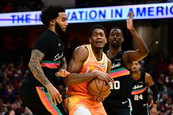 Dec 5, 2025; Cleveland, Ohio, USA; Cleveland Cavaliers forward De'Andre Hunter (12) drives to the basket against San Antonio Spurs forward Julian Champagnie (30) during the second half at Rocket Arena. Mandatory Credit: Ken Blaze-Imagn Images