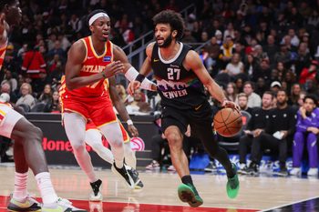 Dec 5, 2025; Atlanta, Georgia, USA; Denver Nuggets guard Jamal Murray (27) drives on Atlanta Hawks forward Onyeka Okongwu (17) in the fourth quarter at State Farm Arena. Mandatory Credit: Brett Davis-Imagn Images