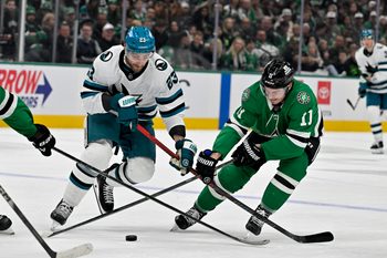 Dec 5, 2025; Dallas, Texas, USA; San Jose Sharks center Barclay Goodrow (23) and Dallas Stars right wing Nathan Bastian (11) battle for control of the puck during the third period at the American Airlines Center. Mandatory Credit: Jerome Miron-Imagn Images