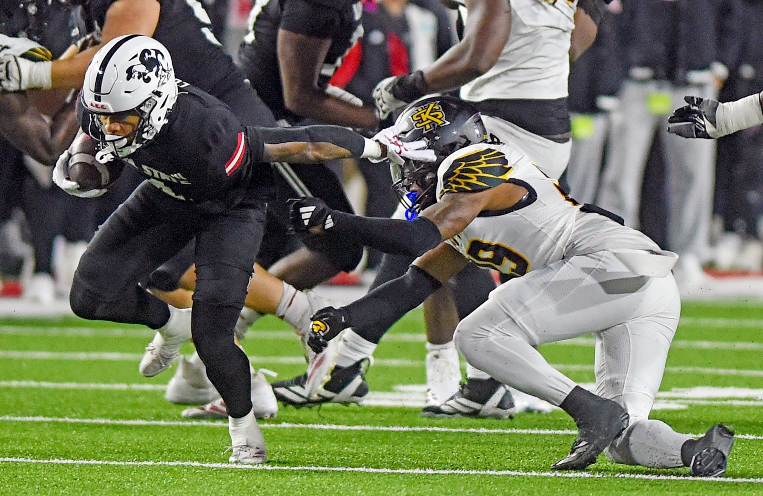 Jax State's Cam Cook tries to evade the tackle of Kennesaw State's Milon Jones during the C-USA Championship at AmFirst Stadium in Jacksonville, Alabama December 5, 2025. (Dave Hyatt / Hyatt Media LLC)
