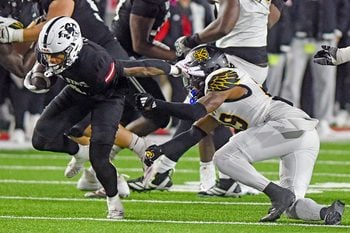 Jax State's Cam Cook tries to evade the tackle of Kennesaw State's Milon Jones during the C-USA Championship at AmFirst Stadium in Jacksonville, Alabama December 5, 2025. (Dave Hyatt / Hyatt Media LLC)