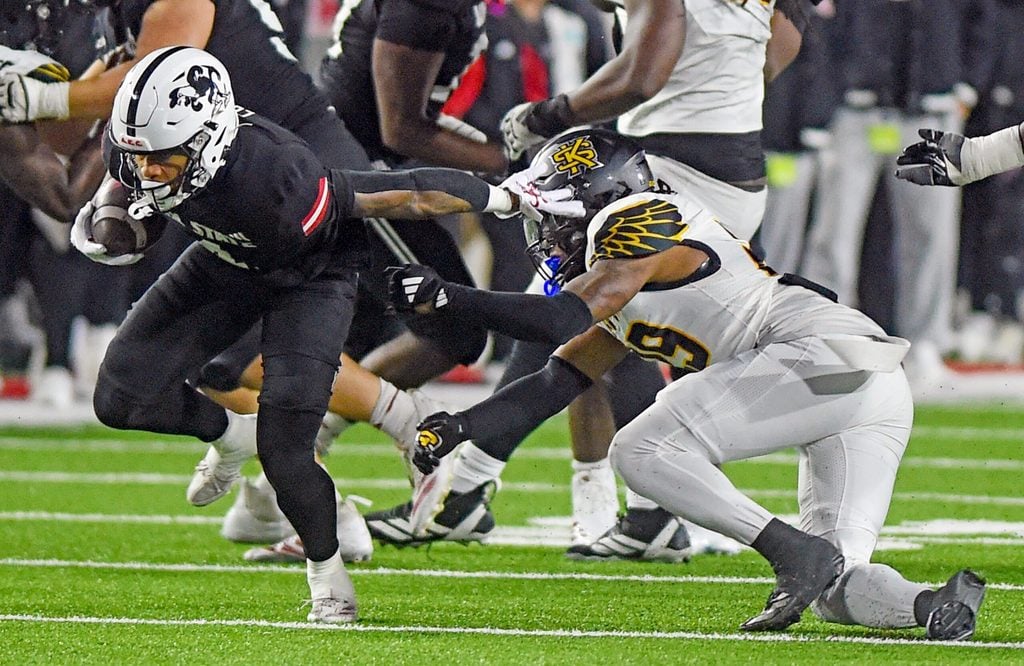 Jax State's Cam Cook tries to evade the tackle of Kennesaw State's Milon Jones during the C-USA Championship at AmFirst Stadium in Jacksonville, Alabama December 5, 2025. (Dave Hyatt / Hyatt Media LLC)