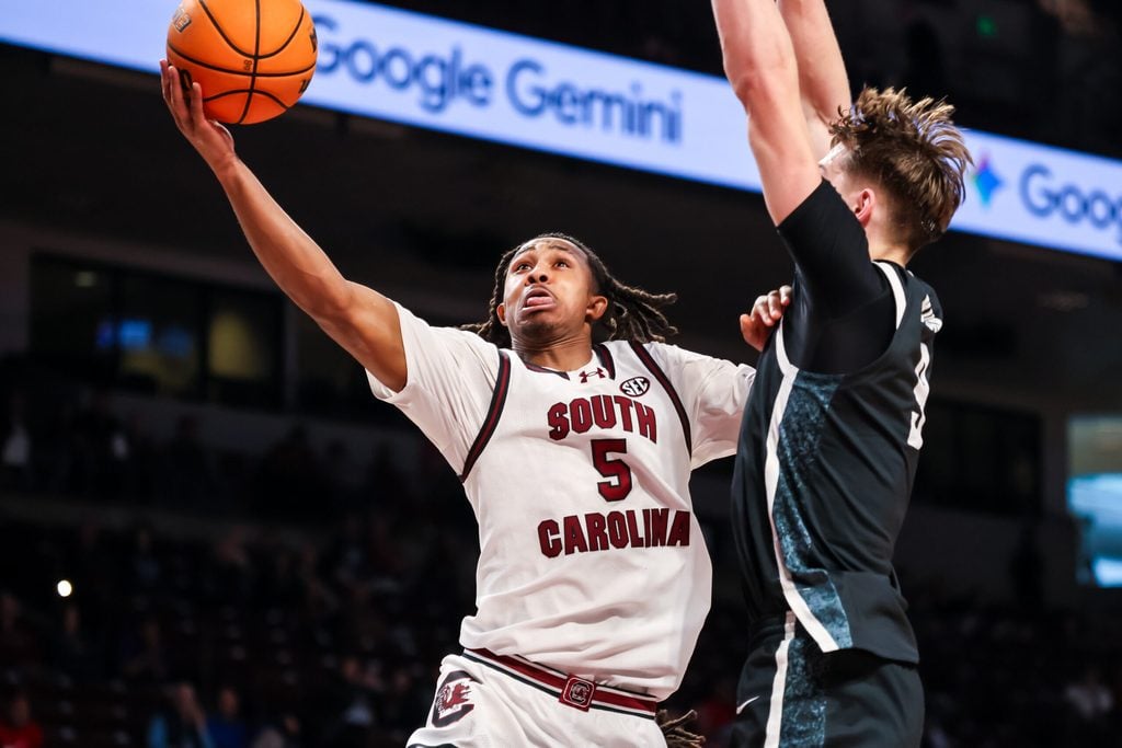 Dec 6, 2025; Columbia, South Carolina, USA; South Carolina Gamecocks guard Meechie Johnson (5) drives past Stetson Hatters forward Collin Kuhl (9) in the first half at Colonial Life Arena. Mandatory Credit: Jeff Blake-Imagn Images