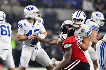 Dec 6, 2025; Arlington, TX, USA; Texas Tech Red Raiders defensive back Miquel Dingle Jr. (21) strips the ball away from BYU Cougars quarterback Bear Bachmeier (47) during the second half at AT&T Stadium. Mandatory Credit: Jerome Miron-Imagn Images
