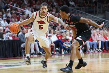 Dec 6, 2025; North Little Rock, Arkansas, USA; Arkansas Razorbacks guard Darius Acuff Jr (5) drives against Fresno State Bulldogs guard Zaon Collins (10) during the second half at Simmons Bank Arena. Arkansas won 82-58. Mandatory Credit: Nelson Chenault-Imagn Images