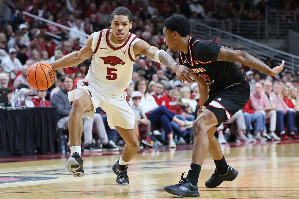 Dec 6, 2025; North Little Rock, Arkansas, USA; Arkansas Razorbacks guard Darius Acuff Jr (5) drives against Fresno State Bulldogs guard Zaon Collins (10) during the second half at Simmons Bank Arena. Arkansas won 82-58. Mandatory Credit: Nelson Chenault-Imagn Images