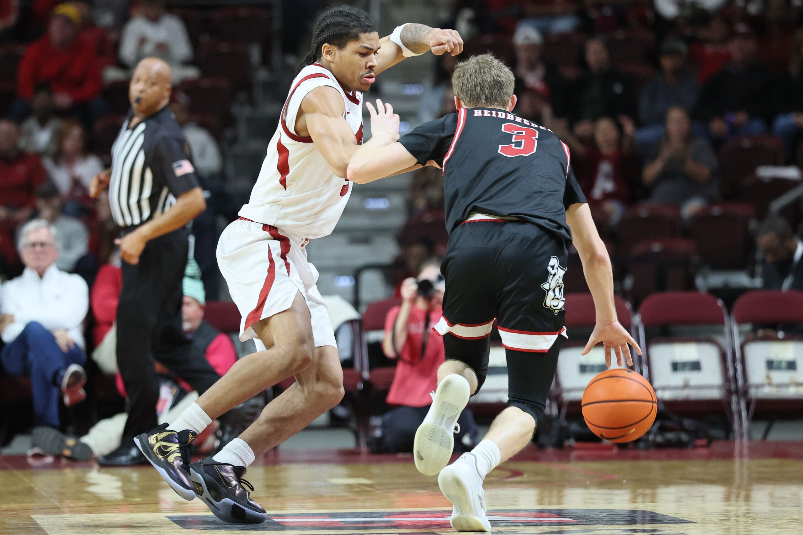 Dec 6, 2025; North Little Rock, Arkansas, USA; Arkansas Razorbacks guard Darius Acuff Jr (5) defends during the second half against Fresno State Bulldogs guard Jake Heidbreder (3) at Simmons Bank Arena. Arkansas won 82-58. Mandatory Credit: Nelson Chenault-Imagn Images