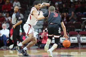 Dec 6, 2025; North Little Rock, Arkansas, USA; Arkansas Razorbacks guard Darius Acuff Jr (5) defends during the second half against Fresno State Bulldogs guard Jake Heidbreder (3) at Simmons Bank Arena. Arkansas won 82-58. Mandatory Credit: Nelson Chenault-Imagn Images
