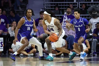 Dec 6, 2025; Manhattan, Kansas, USA; Kansas State Wildcats guard Nate Johnson (34) is guarded by Seton Hall Pirates guards AJ Staton-McCray (14) and Adam Clark (0) during the first half at Bramlage Coliseum. Mandatory Credit: Scott Sewell-Imagn Images