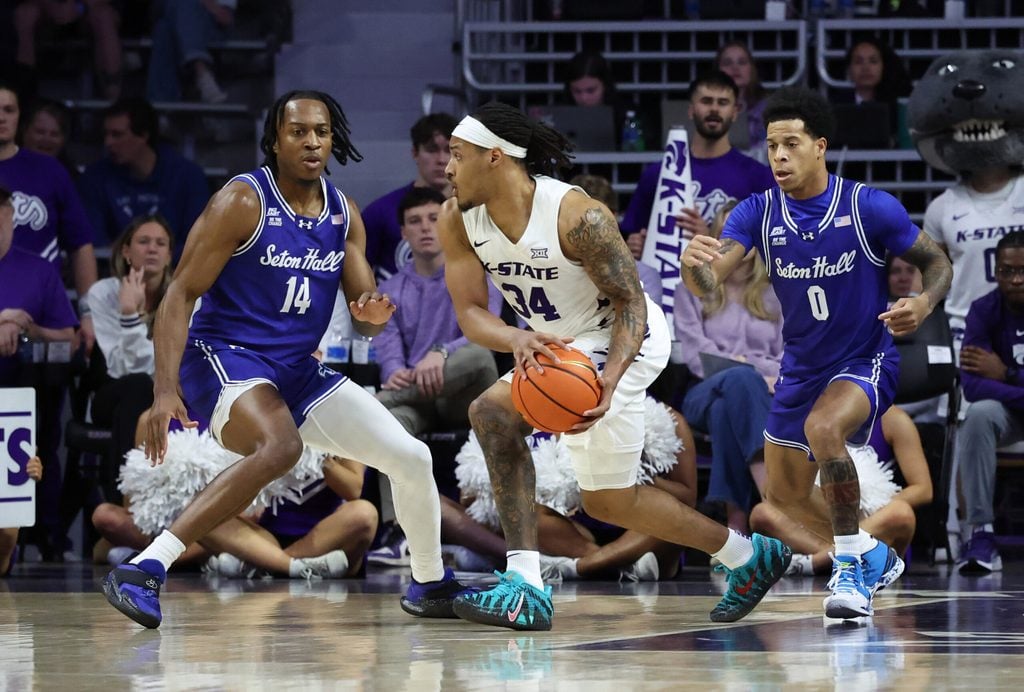 Dec 6, 2025; Manhattan, Kansas, USA; Kansas State Wildcats guard Nate Johnson (34) is guarded by Seton Hall Pirates guards AJ Staton-McCray (14) and Adam Clark (0) during the first half at Bramlage Coliseum. Mandatory Credit: Scott Sewell-Imagn Images