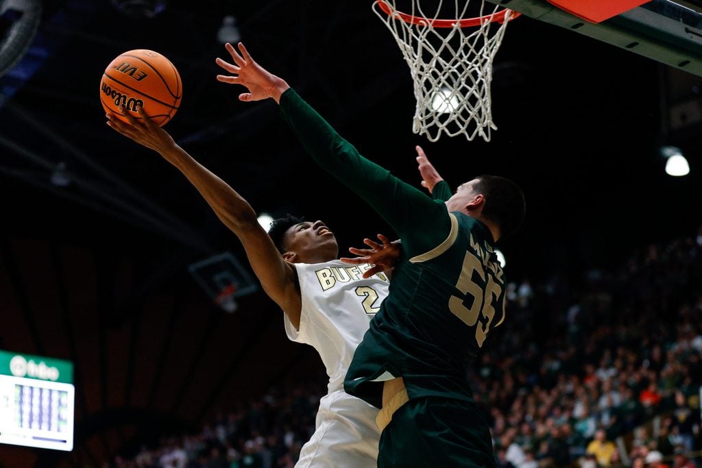 Dec 6, 2025; Fort Collins, Colorado, USA; Colorado Buffaloes guard Isaiah Johnson (2) drives to the net against Colorado State Rams forward Jevin Muniz (55) in the second half at Moby Arena. Mandatory Credit: Isaiah J. Downing-Imagn Images