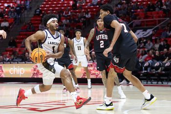 Dec 6, 2025; Salt Lake City, Utah, USA; California Baptist Lancers guard Dominique Daniels Jr. (1) drives to the basket against Utah Utes forward Josh Hayes (7) during the first half at Jon M. Huntsman Center. Mandatory Credit: Rob Gray-Imagn Images
