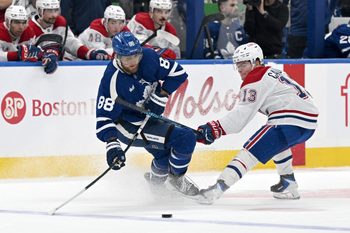 Dec 6, 2025; Toronto, Ontario, CAN;  Toronto Maple Leafs forward William Nylander (88) moves the puck past Montreal Canadiens forward Cole Caufield (13) in the second period at Scotiabank Arena. Mandatory Credit: Dan Hamilton-Imagn Images