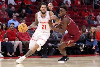 Dec 6, 2025; Houston, TX, USA; Houston Cougars guard Emanuel Sharp (21) dribbles the ball as Florida State Seminoles forward Thomas Bassong (3) defends during the first half at Toyota Center. Mandatory Credit: Troy Taormina-Imagn Images