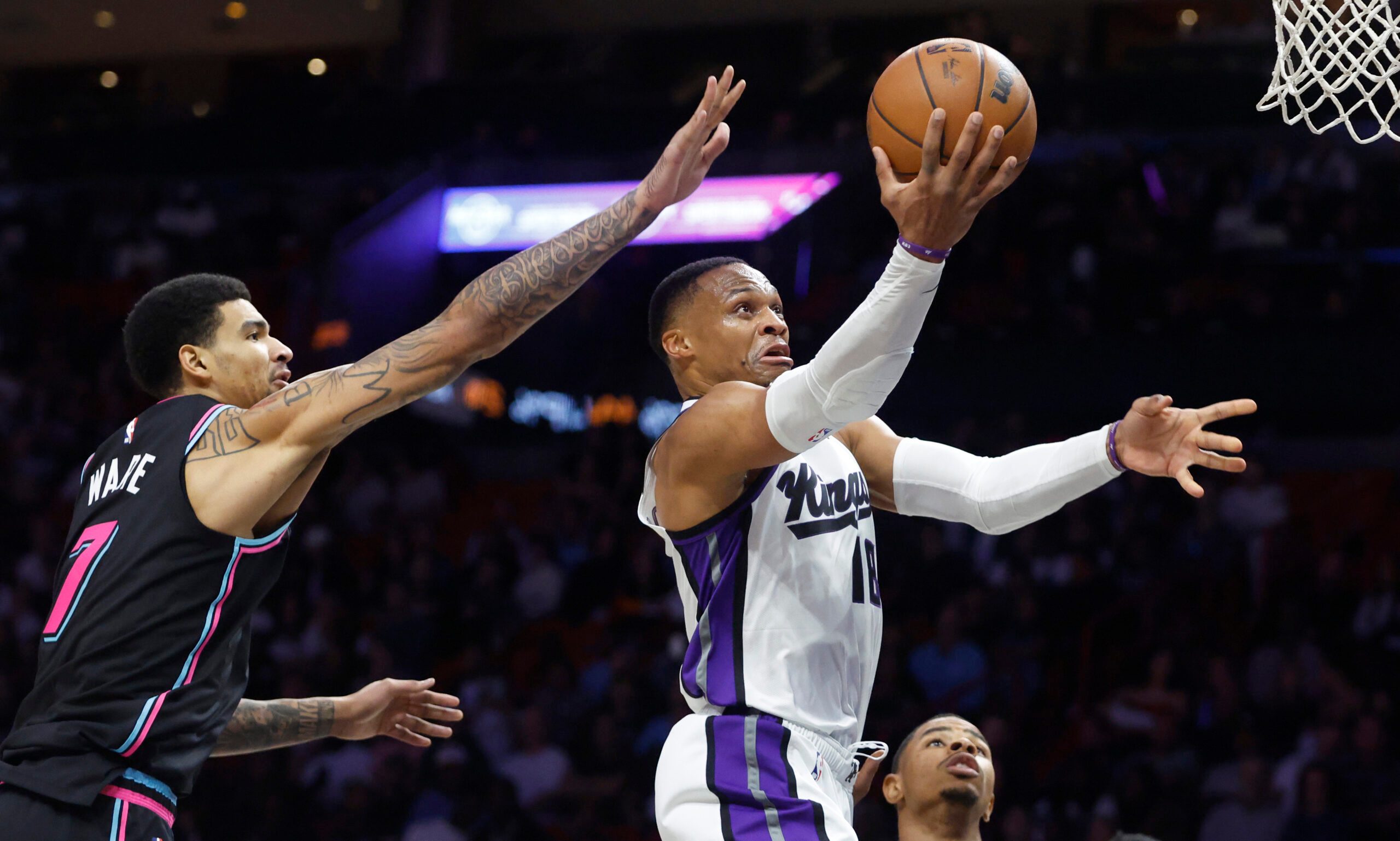Dec 6, 2025; Miami, Florida, USA;  Sacramento Kings guard Russell Westbrook (18) shoots around Miami Heat center Kel'el Ware (7) during the second half at Kaseya Center. Mandatory Credit: Rhona Wise-Imagn Images