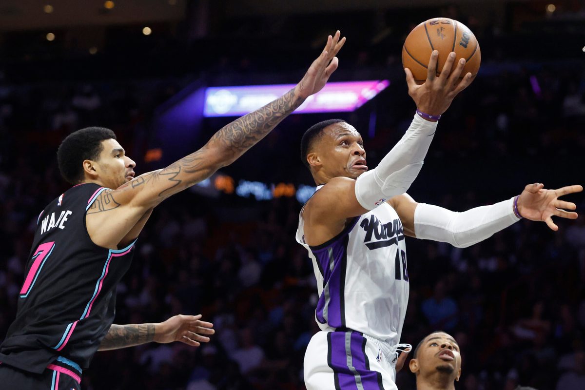 Dec 6, 2025; Miami, Florida, USA; Sacramento Kings guard Russell Westbrook (18) shoots around Miami Heat center Kel'el Ware (7) during the second half at Kaseya Center. Mandatory Credit: Rhona Wise-Imagn Images