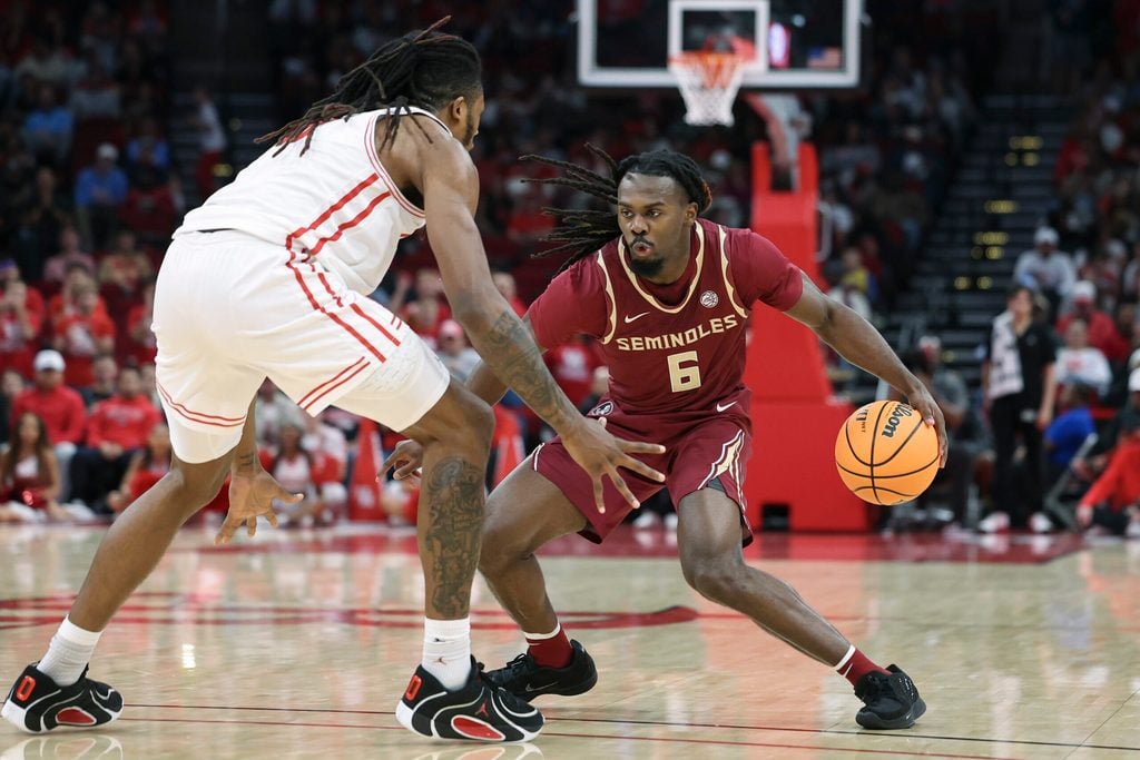 Dec 6, 2025; Houston, TX, USA; Florida State Seminoles guard Robert McCray V (6) dribbles the ball as Houston Cougars forward Joseph Tugler (11) defends during the second half at Toyota Center. Mandatory Credit: Troy Taormina-Imagn Images