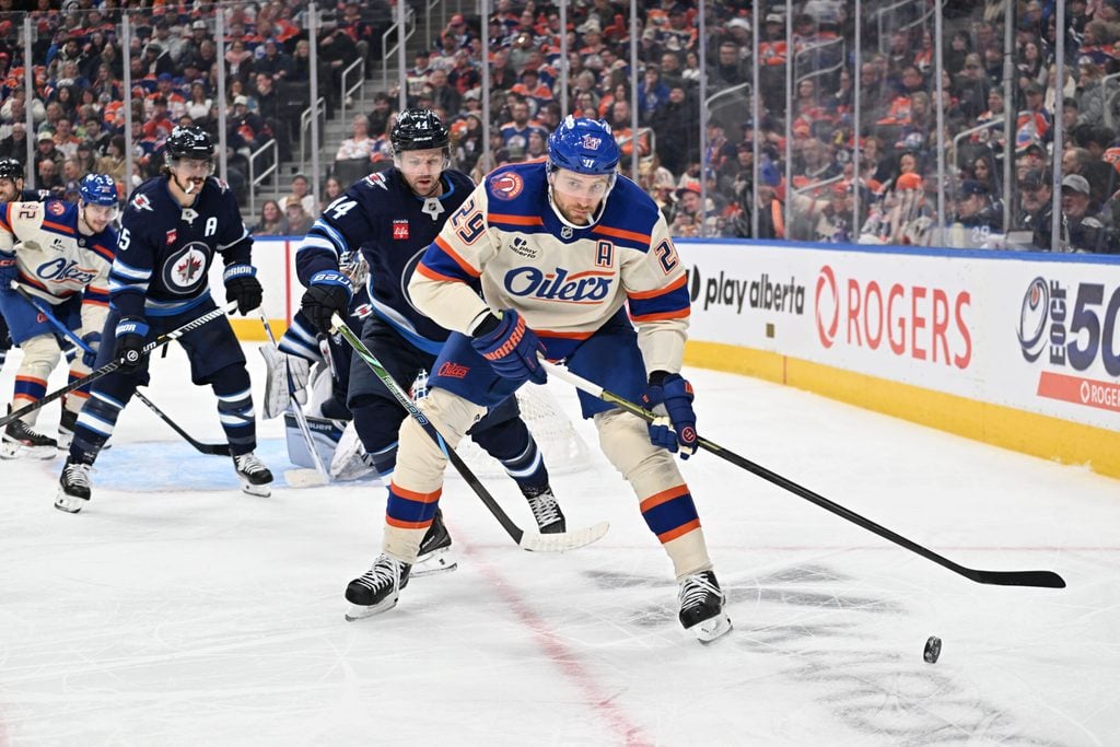 Dec 6, 2025; Edmonton, Alberta, CAN; Edmonton Oilers center Leon Draisaitl (29) goes for the puck with Winnipeg Jets defenseman Josh Morrissey (44) during the third period at Rogers Place. Mandatory Credit: Walter Tychnowicz-Imagn Images