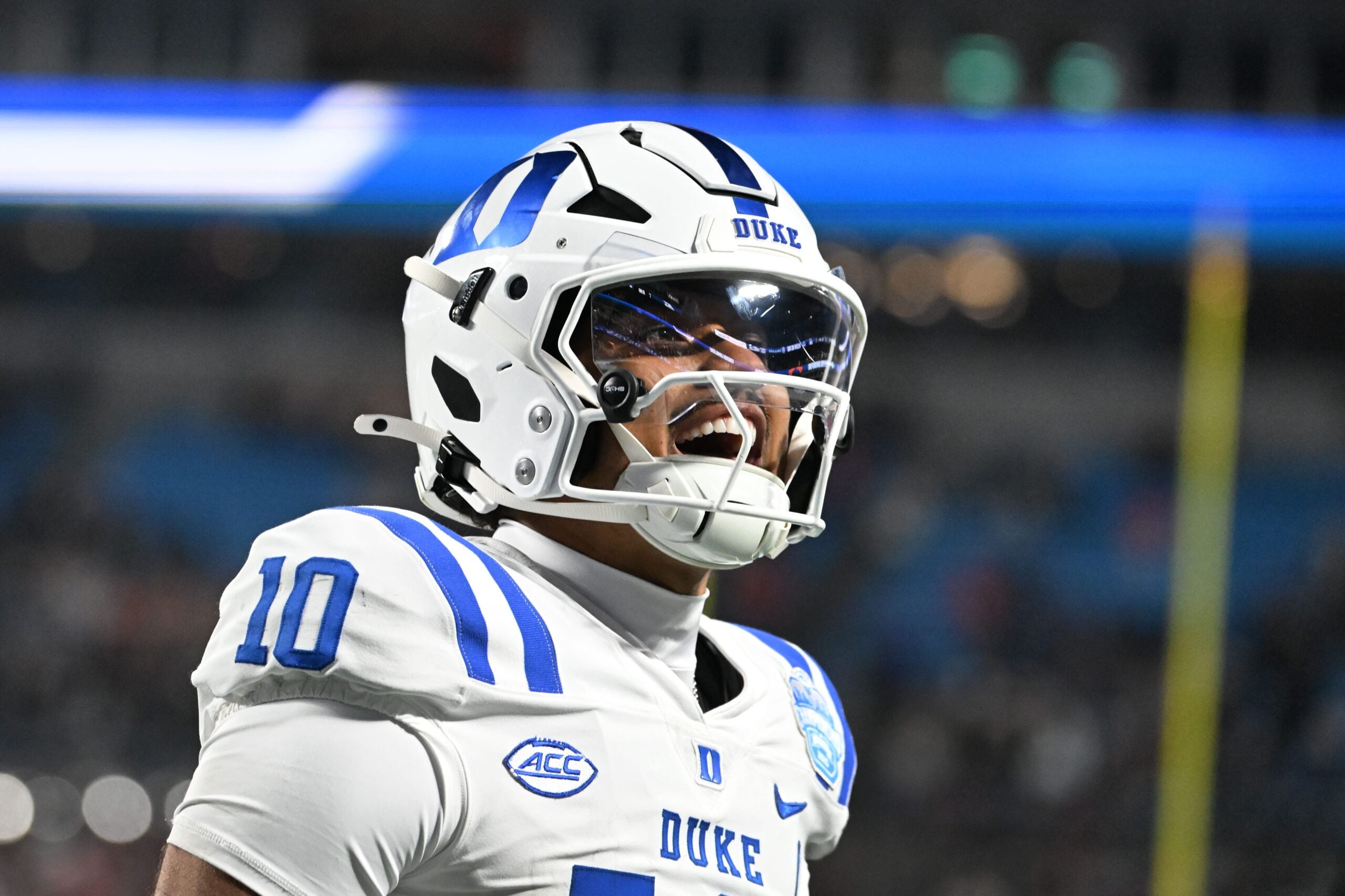 Dec 6, 2025; Charlotte, NC, USA; Duke Blue Devils quarterback Darian Mensah (10) celebrates after the Blue Devils score a touchdown in overtime during the  ACC Championship game at Bank of America Stadium. Mandatory Credit: Bob Donnan-Imagn Images